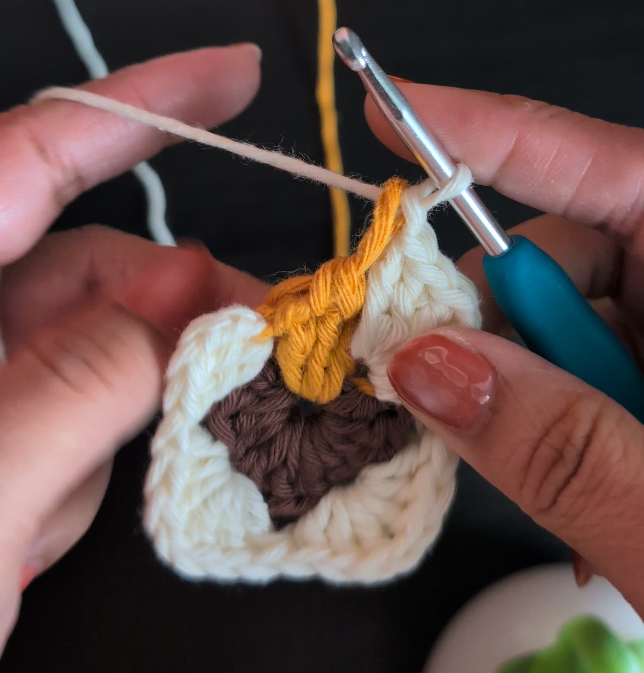 Round 2, with the first off-white granny stitches around the diya